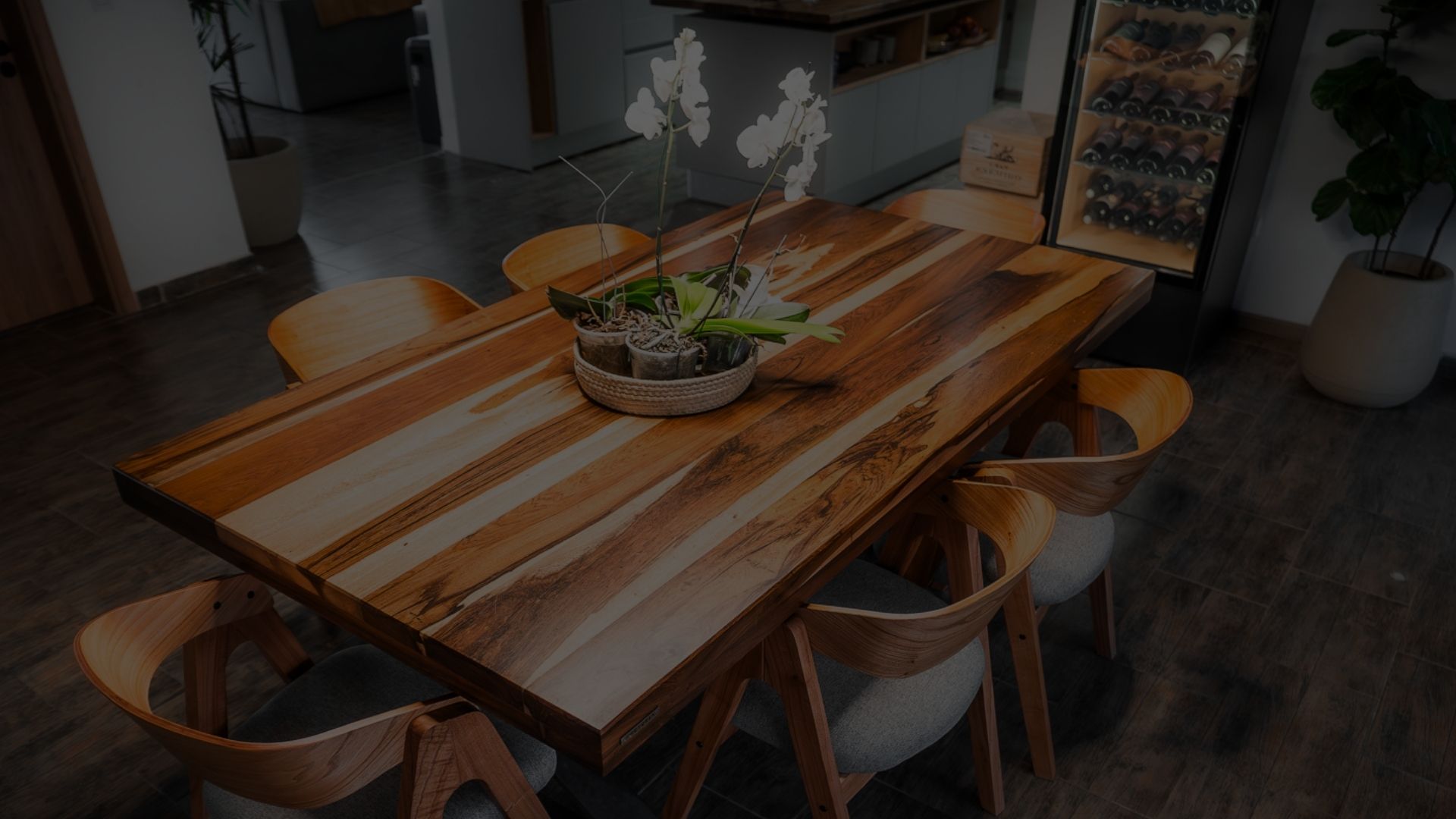 Mesa de comedor de madera maciza con vetas claras y oscuras y sillas de madera curva, con un centro de mesa de orquídeas Mesa de comedor de madera maciza con vetas claras y oscuras y sillas de madera curva, con un centro de mesa de orquídeas